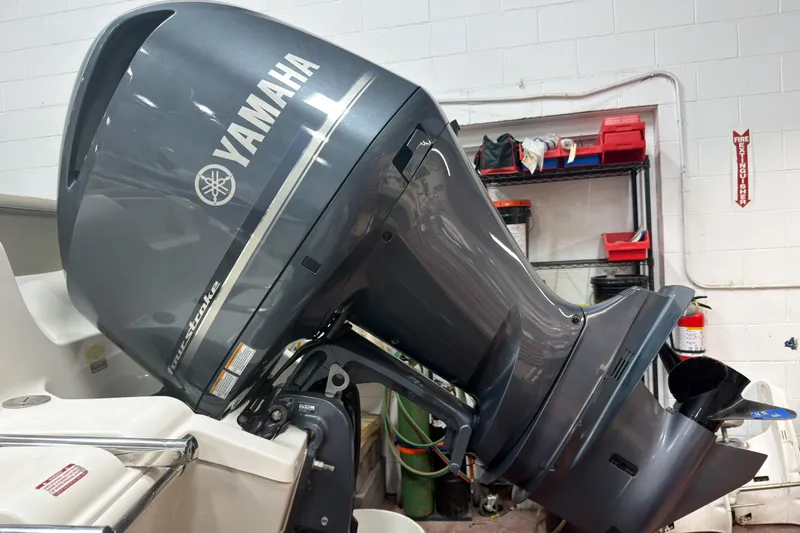 Slide: The Image of 2023 Key West 239 DFS boat with Yamaha outboard motor in a garage setting. - 26