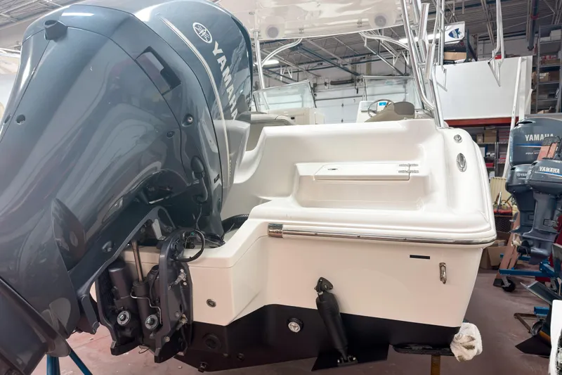 Slide: The Image of 2023 Key West 239 DFS boat with Yamaha outboard motor in a workshop. - 28