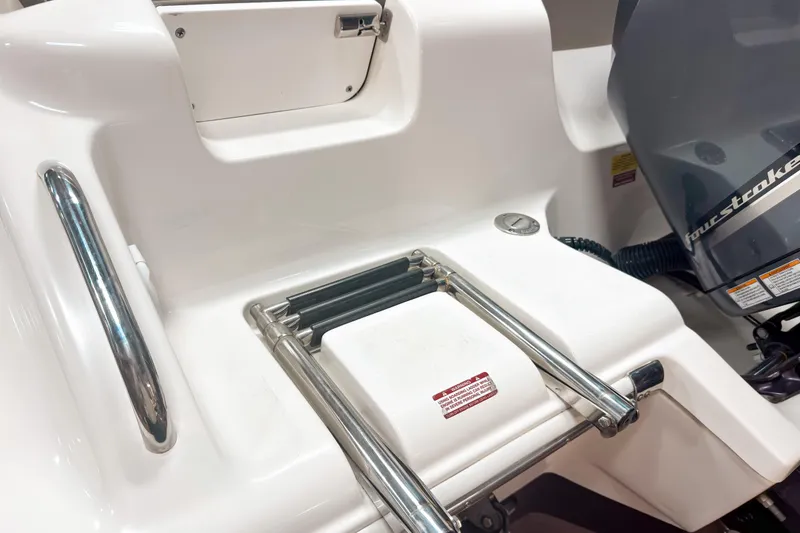 Slide: The Image of 2023 Key West 239 DFS boat with ladder and four-stroke engine detail. - 6