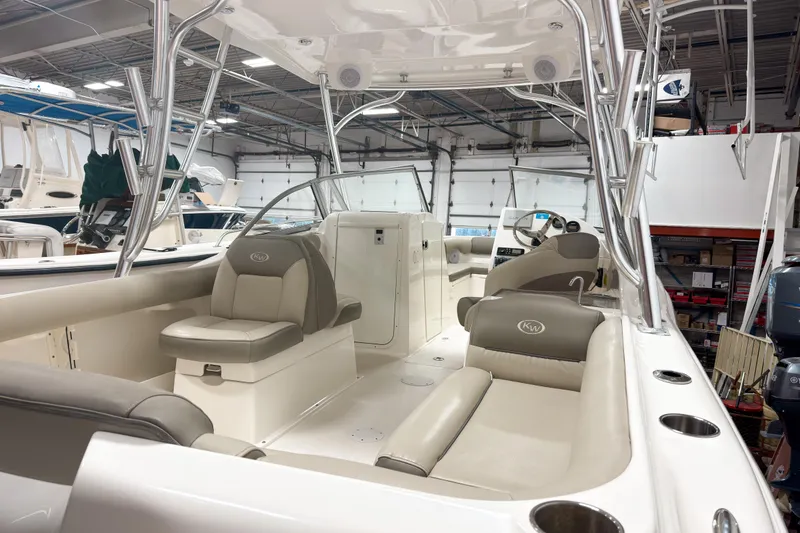 Slide: The Image of 2023 Key West 239 DFS boat interior with seating and helm in a showroom. - 7