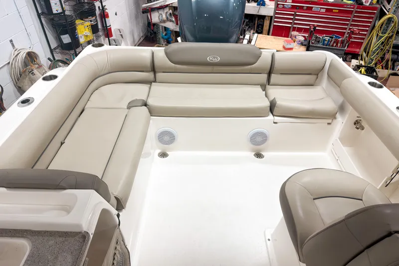 Slide: The Image of 2023 Key West 239 DFS boat interior with beige seating and storage compartments. - 8
