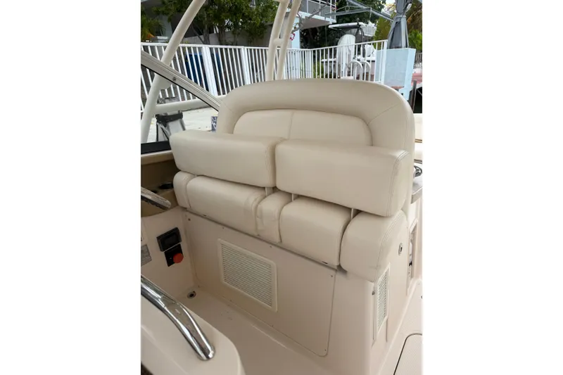 Slide: The Image of 2015 Grady-White Freedom 335 boat interior with beige seating and helm area. - 10