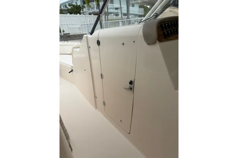 Slide: The Image of 2015 Grady-White Freedom 335 boat interior, featuring a sleek cabin door design. - 14