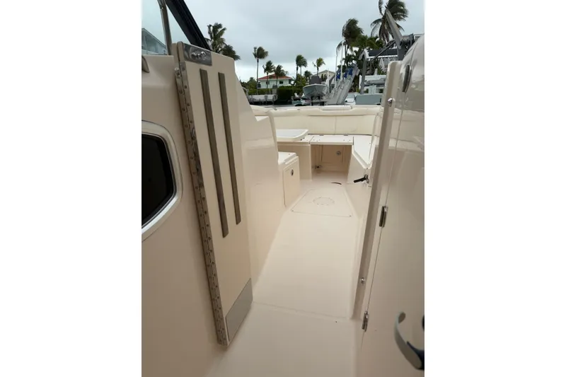 Slide: The Image of 2015 Grady-White Freedom 335 boat interior with open deck and storage compartments. - 15