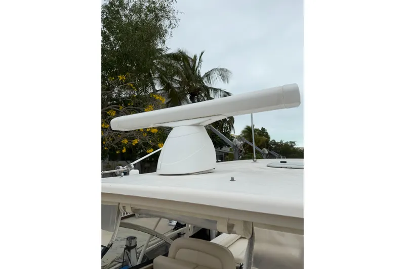 Slide: The Image of Radar system on 2015 Grady-White Freedom 335 boat, surrounded by tropical foliage. - 18