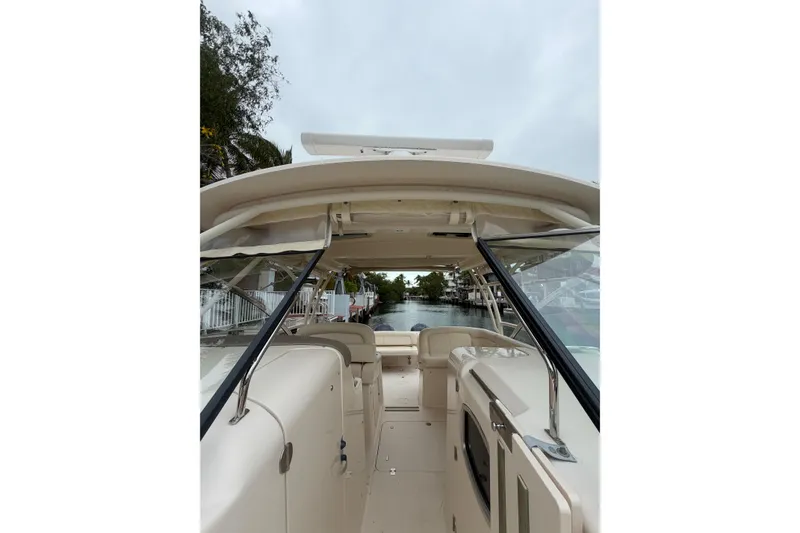 Slide: The Image of 2015 Grady-White Freedom 335 boat interior view, featuring spacious seating and sleek design. - 20