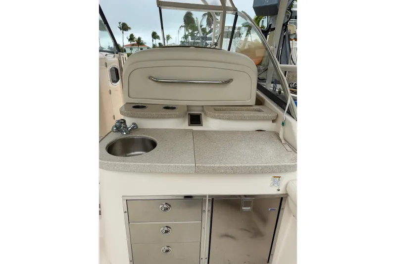 Slide: The Image of 2015 Grady-White Freedom 335 boat interior with sink and storage compartments. - 5