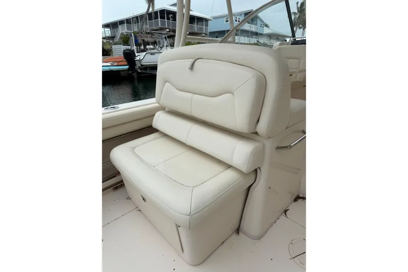Slide: The Image of Cream leather seat on 2015 Grady-White Freedom 335 boat, dockside view. - 6