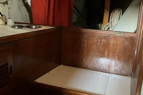 Slide: The Image of 1979 Bristol Channel Cutter interior with wooden cabinetry and compact sink area. - 17