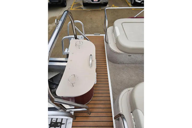Slide: The Image of 2012 Tahoe Pontoon Vision 25' interior with seating and wooden deck. - 13
