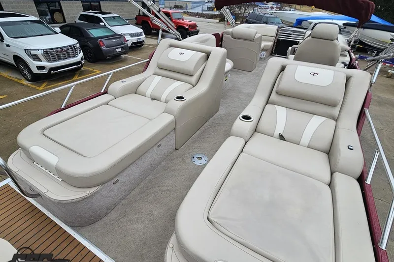 Slide: The Image of 2012 Tahoe Pontoon Vision 25' with luxurious beige seating and cup holders. - 15