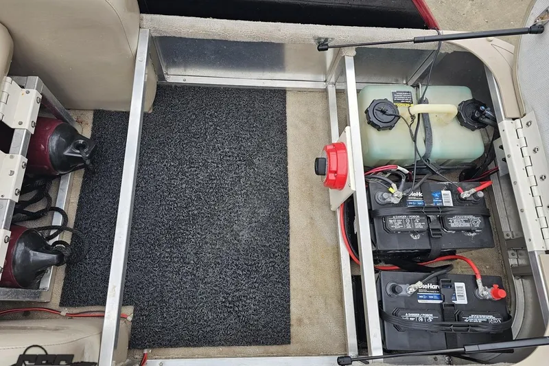 Slide: The Image of 2012 Tahoe Pontoon Vision 25' battery and fuel compartment with wiring and storage. - 20