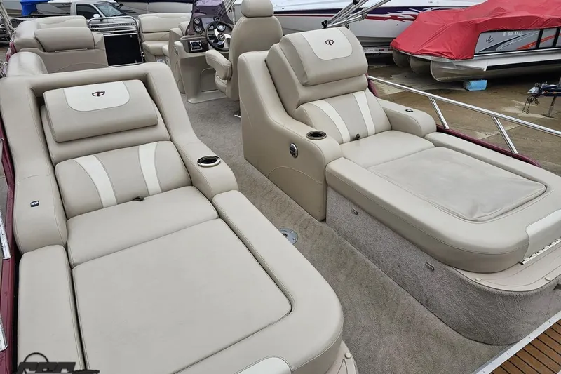 Slide: The Image of Luxurious seating on a 2012 Tahoe Pontoon Vision 25' boat, featuring beige upholstery. - 25