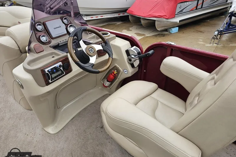 Slide: The Image of 2012 Tahoe Pontoon Vision 25' boat interior with steering wheel and control panel. - 35