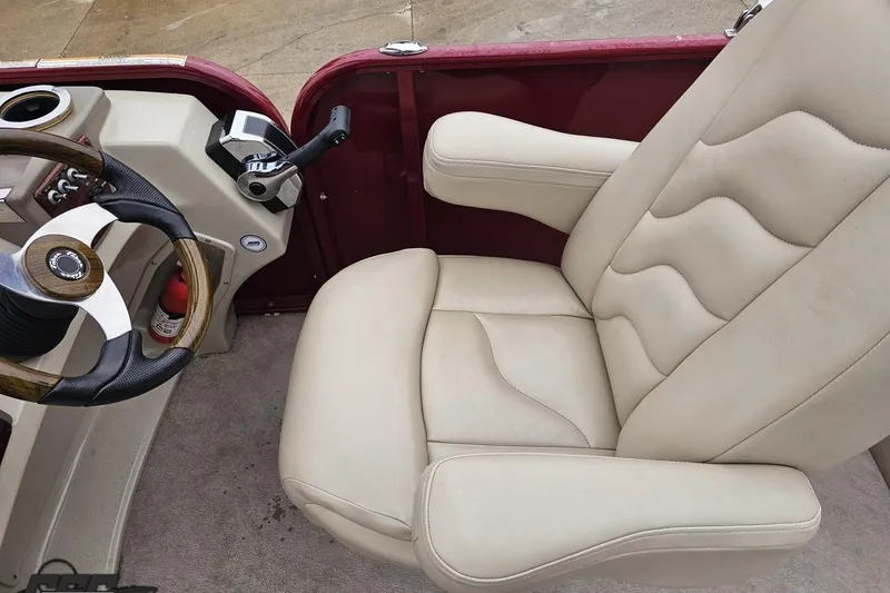 Slide: The Image of Captain's chair and steering console of 2012 Tahoe Pontoon Vision 25' boat. - 36