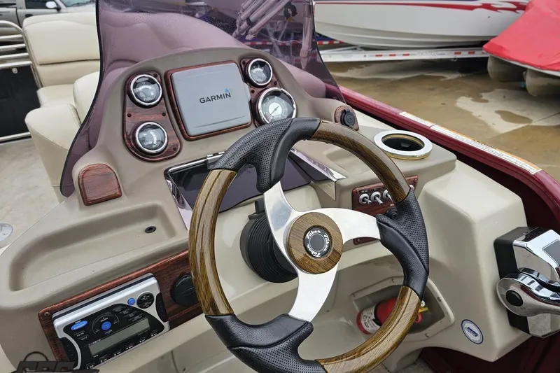 Slide: The Image of Steering console of a 2012 Tahoe Pontoon Vision 25' with Garmin navigation system. - 37