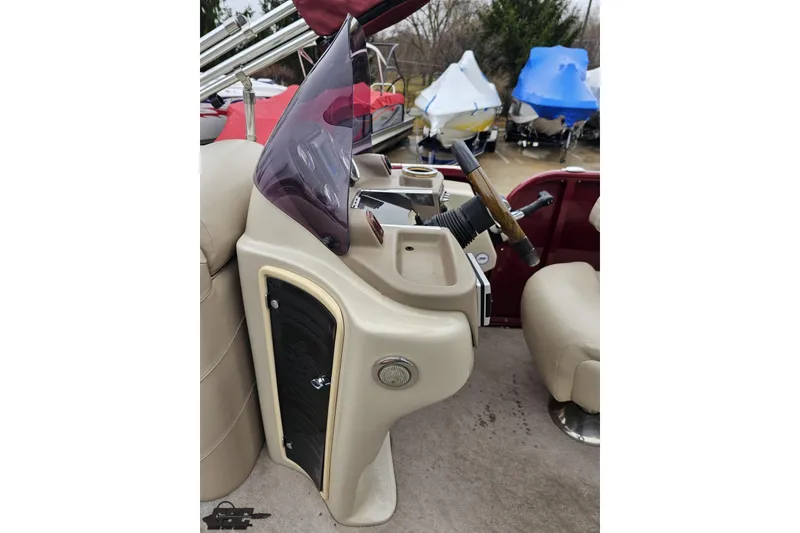 Slide: The Image of 2012 Tahoe Pontoon Vision 25' helm with steering wheel and controls. - 42