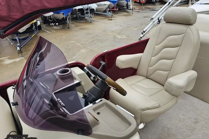 Slide: The Image of 2012 Tahoe Pontoon Vision 25' boat interior with beige captain's chair and steering console. - 43