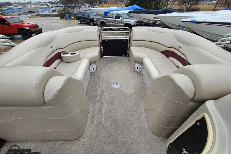 Slide: The Image of 2012 Tahoe Pontoon Vision 25' interior with beige seating and cup holders. - 44