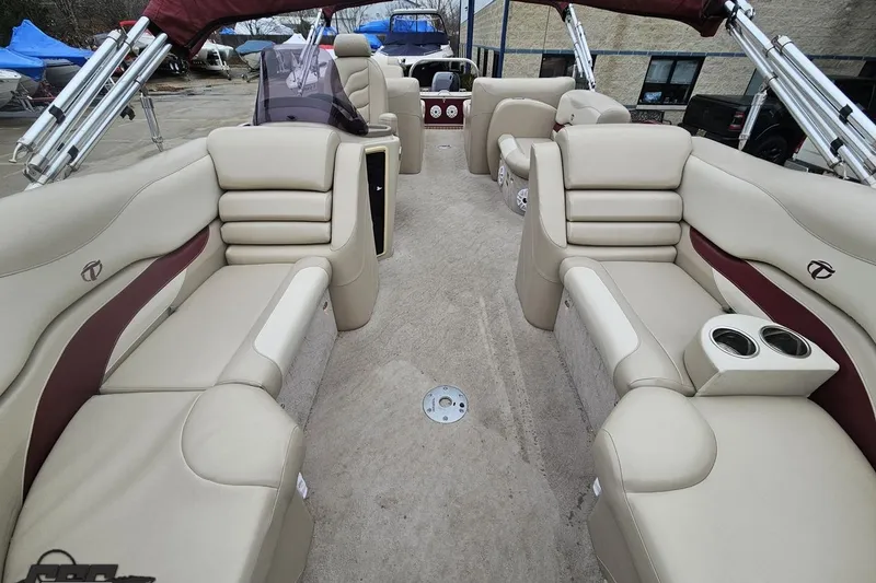 Slide: The Image of 2012 Tahoe Pontoon Vision 25' with beige seating and cup holders, docked outdoors. - 53