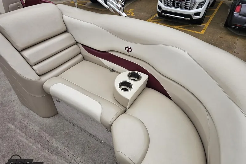 Slide: The Image of 2012 Tahoe Pontoon Vision 25' boat interior with beige seating and cup holders. - 55
