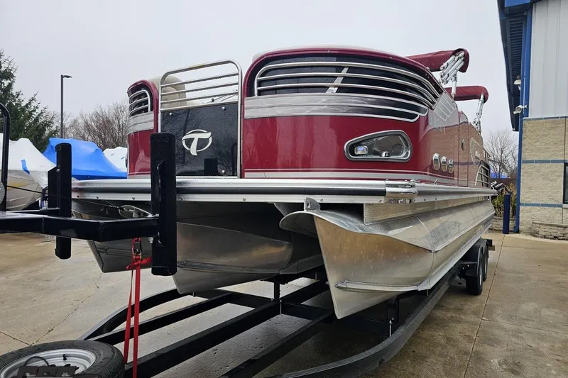 Slide: The Image of 2012 Tahoe Pontoon Vision 25' boat on trailer, red exterior, parked outdoors. - 6