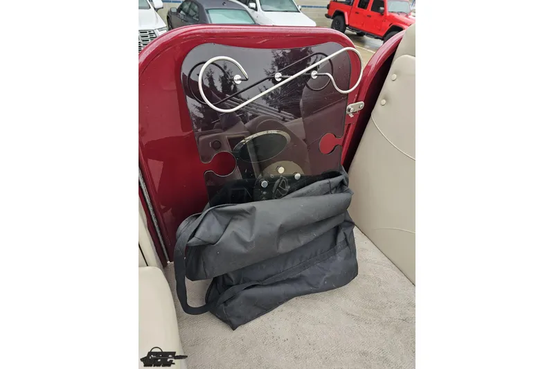 Slide: The Image of 2012 Tahoe Pontoon Vision 25' interior with red panel and black bag. - 60