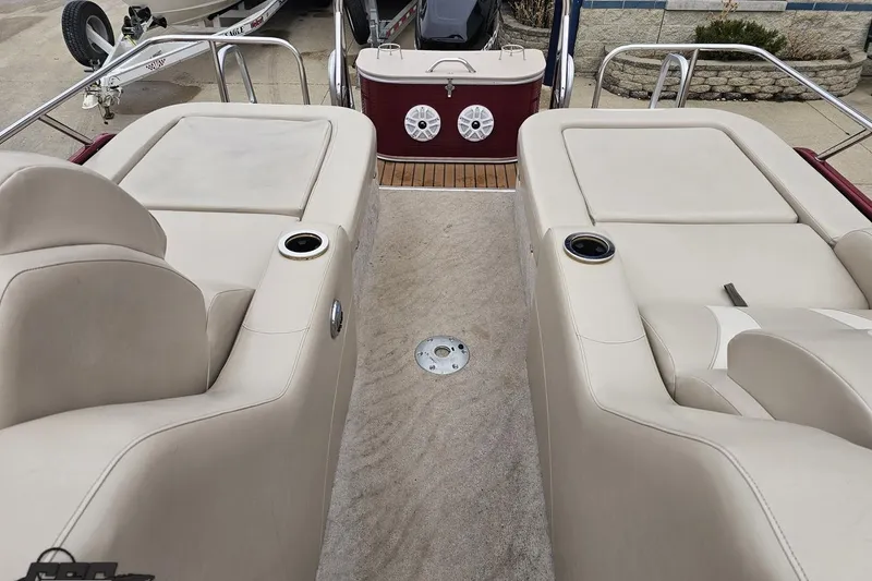 Slide: The Image of 2012 Tahoe Pontoon Vision 25' interior with beige seating and cup holders. - 64