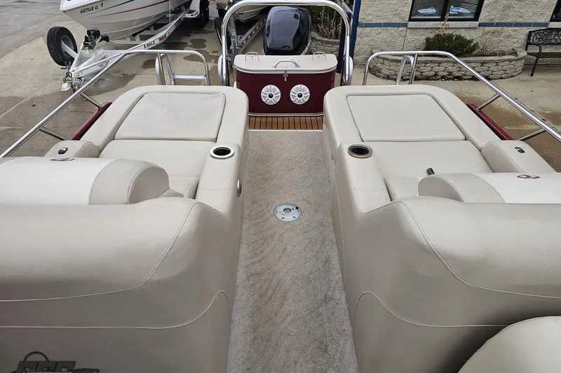 Slide: The Image of 2012 Tahoe Pontoon Vision 25' interior with beige seating and cup holders. - 65