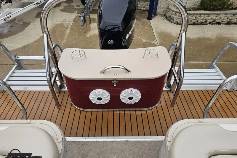 Slide: The Image of 2012 Tahoe Pontoon Vision 25' boat with wooden deck and rear seating area. - 68