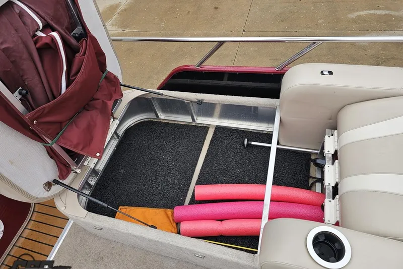 Slide: The Image of 2012 Tahoe Pontoon Vision 25' boat interior with storage, pool noodles, and cup holder. - 69