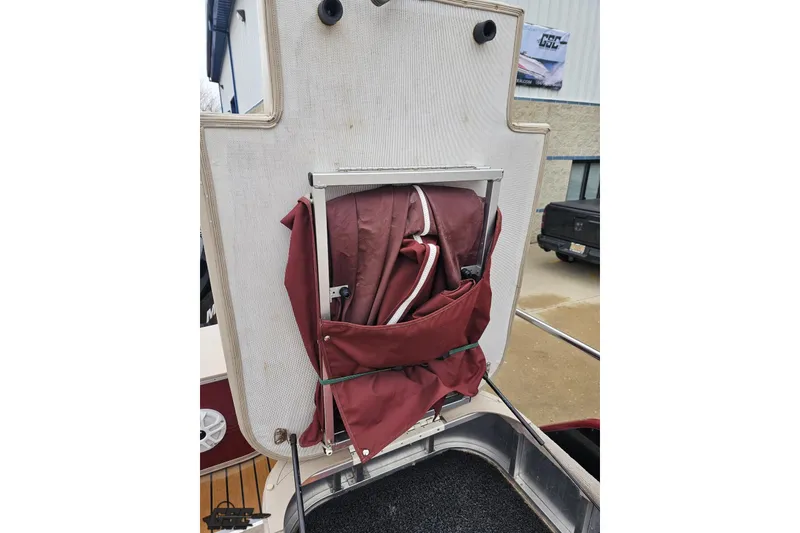 Slide: The Image of 2012 Tahoe Pontoon Vision 25' with folded maroon canopy on deck. - 70