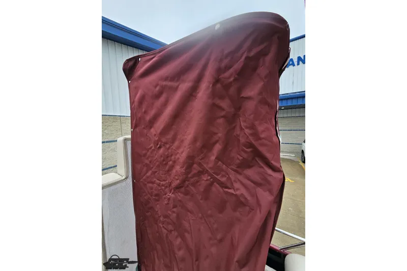 Slide: The Image of Maroon cover on 2012 Tahoe Pontoon Vision 25' boat, outdoor setting. - 71