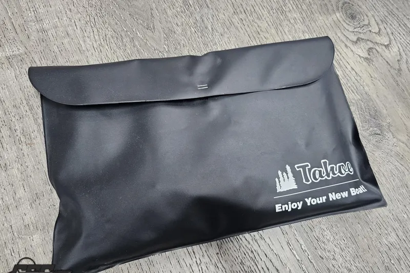 Slide: The Image of Black Tahoe Pontoon pouch on wooden surface, labeled "Enjoy Your New Boat." - 72