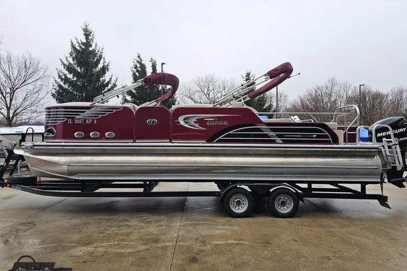 Slide: The Image of 2012 Tahoe Pontoon Vision 25' boat on trailer, maroon and silver design, parked outdoors. - 8