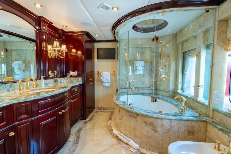 Slide: The Image of Luxurious bathroom on 2006 Trinity Tri-Deck Motor Yacht with marble and gold accents. - 11