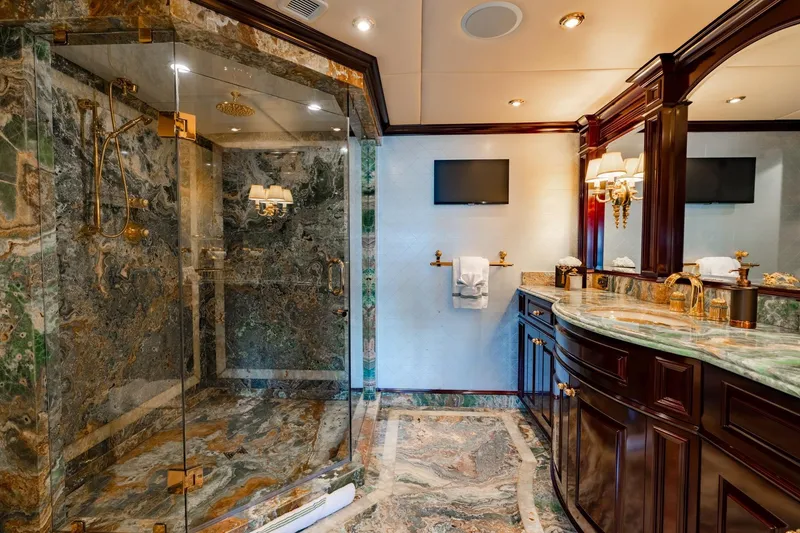 Slide: The Image of Luxurious marble bathroom on 2006 Trinty Tri-Deck Motor Yacht with elegant fixtures and vanity. - 12