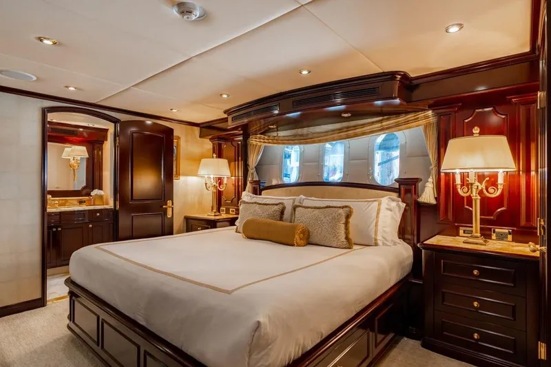 Slide: The Image of Luxurious bedroom interior on 2006 Trinity Tri-Deck Motor Yacht with elegant wood finishes. - 15