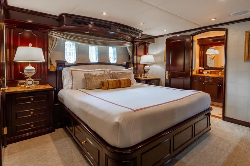 Slide: The Image of Luxurious bedroom interior on 2006 Trinity Tri-Deck Motor Yacht with elegant wood furnishings. - 17