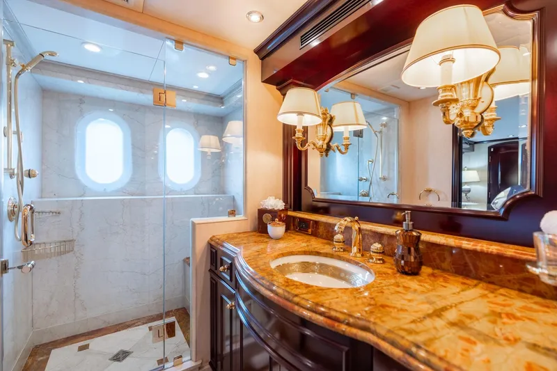 Slide: The Image of Luxurious bathroom on 2006 Trinity Tri-Deck Motor Yacht with marble countertop and glass shower. - 18