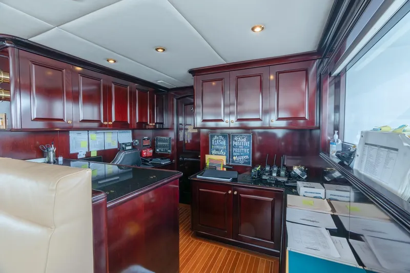 Slide: The Image of Luxurious 2006 Trinity Tri-Deck Motor Yacht interior with rich wood cabinetry and modern equipment. - 23