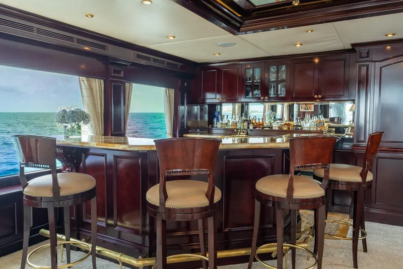 Slide: The Image of Luxurious yacht bar interior with ocean view, featuring elegant wood finishes and plush seating. - 25