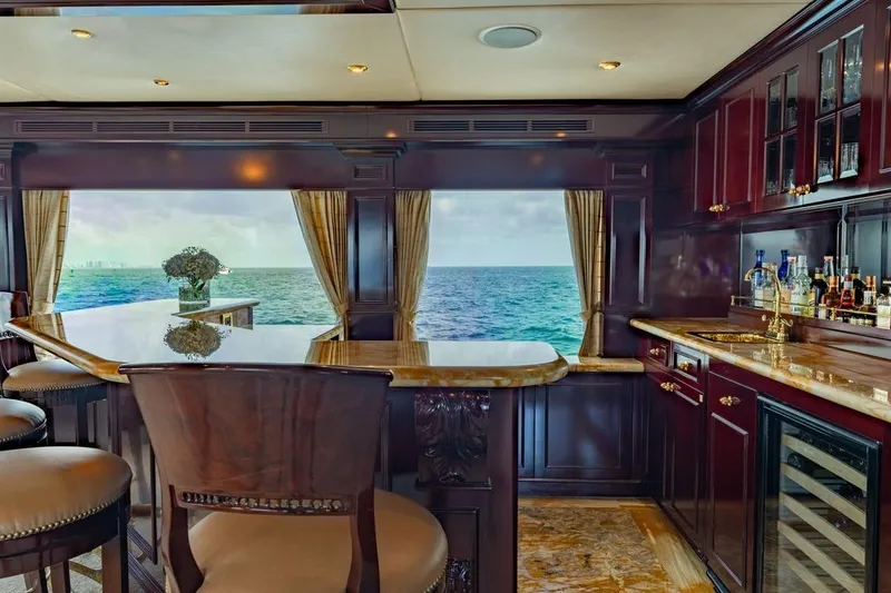 Slide: The Image of Luxurious interior of 2006 Trinity Tri-Deck Motor Yacht with ocean view and elegant bar area. - 26