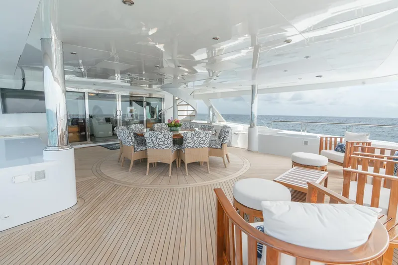 Slide: The Image of Luxurious 2006 Trinity Tri-Deck Motor Yacht with elegant outdoor seating and ocean view. - 29