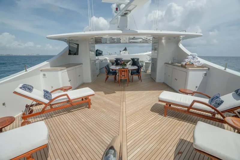 Slide: The Image of Luxurious 2006 Trinity Tri-Deck Motor Yacht deck with sun loungers and dining area. - 31