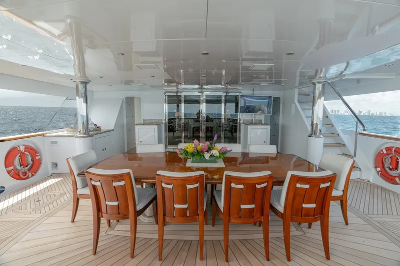 Slide: The Image of Luxurious 2006 Trinity Tri-Deck Motor Yacht dining area with ocean view and elegant seating. - 34
