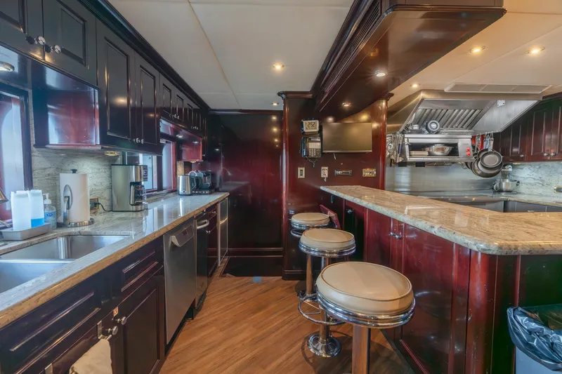Slide: The Image of Luxurious kitchen interior of 2006 Trinity Tri-Deck Motor Yacht with modern appliances and bar seating. - 6