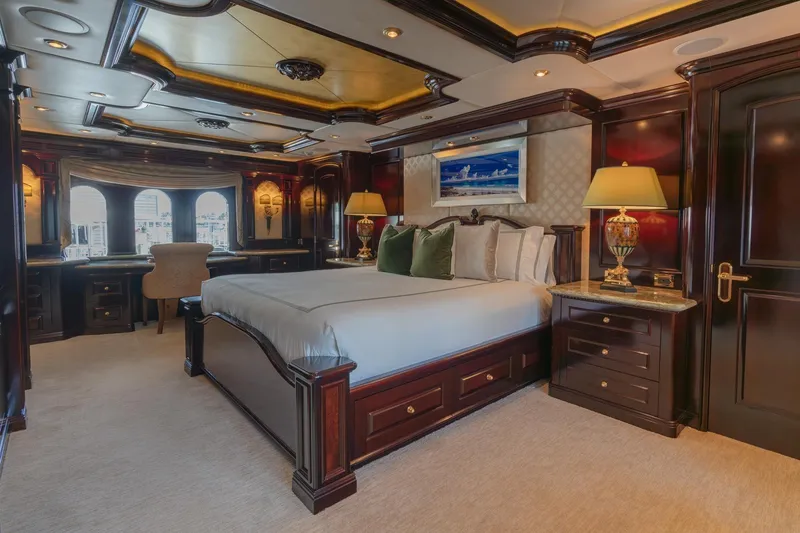 Slide: The Image of Luxurious bedroom interior on 2006 Trinity Tri-Deck Motor Yacht with elegant wood finishes. - 8