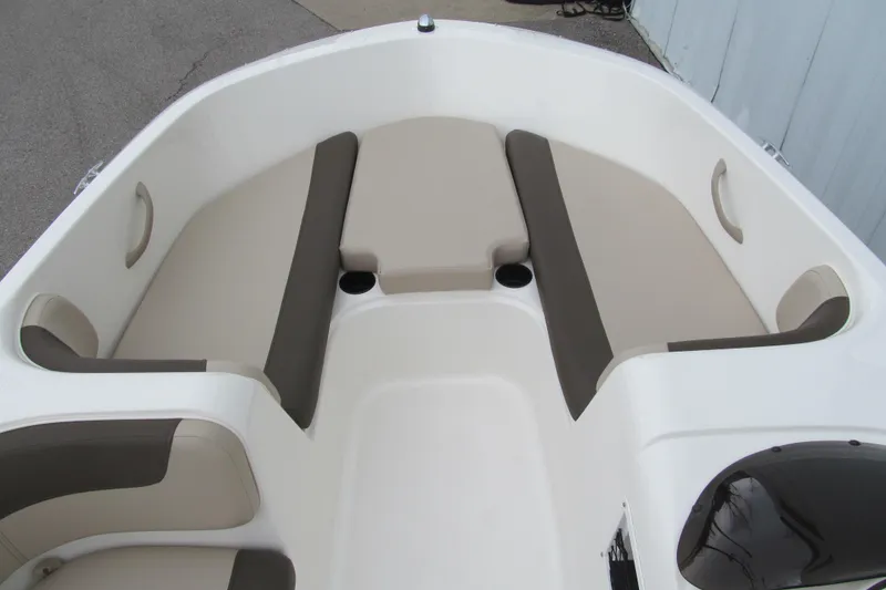 Slide: The Image of 2017 Bayliner Element E18 boat interior with beige seating and cup holders. - 6