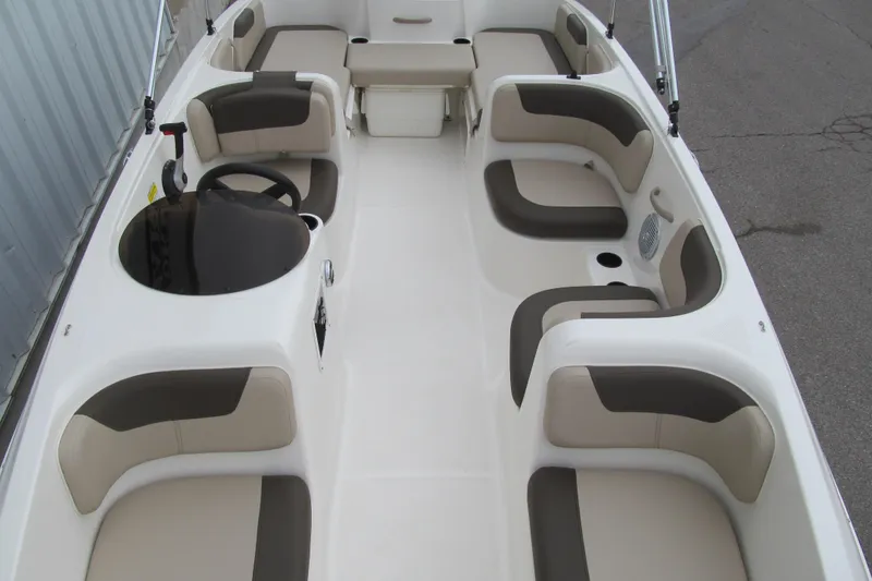 Slide: The Image of 2017 Bayliner Element E18 boat interior with beige and gray seating arrangement. - 9
